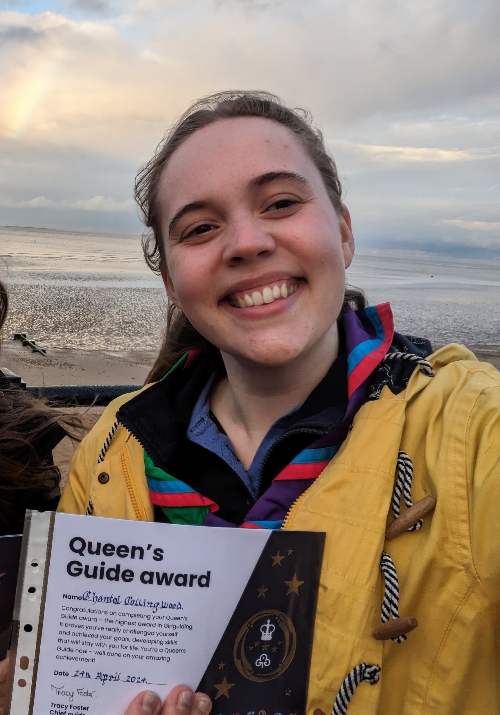 Chantal holding her Queen's Guide certificate