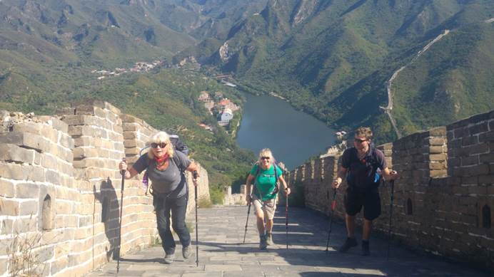 Two women walking up a steep section of the Great Wall