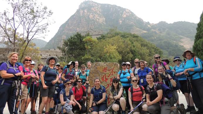 Group of Girlguiding China trekkers standing in front of a peak