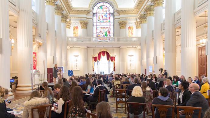 Speaker addresses attendees at Mansion House in an elegant room