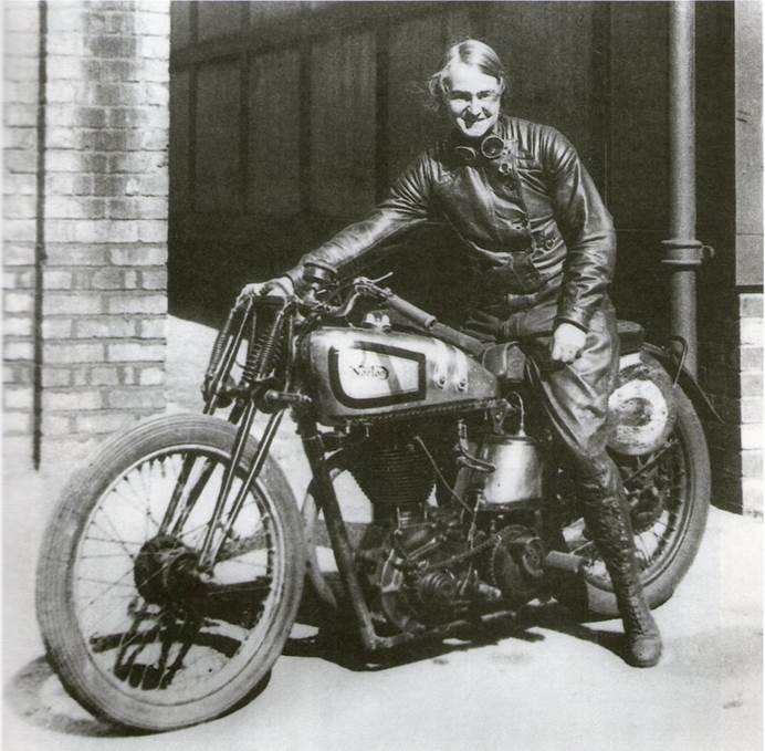 A black and white photo of Beatrice Shilling sitting on a motorbike.