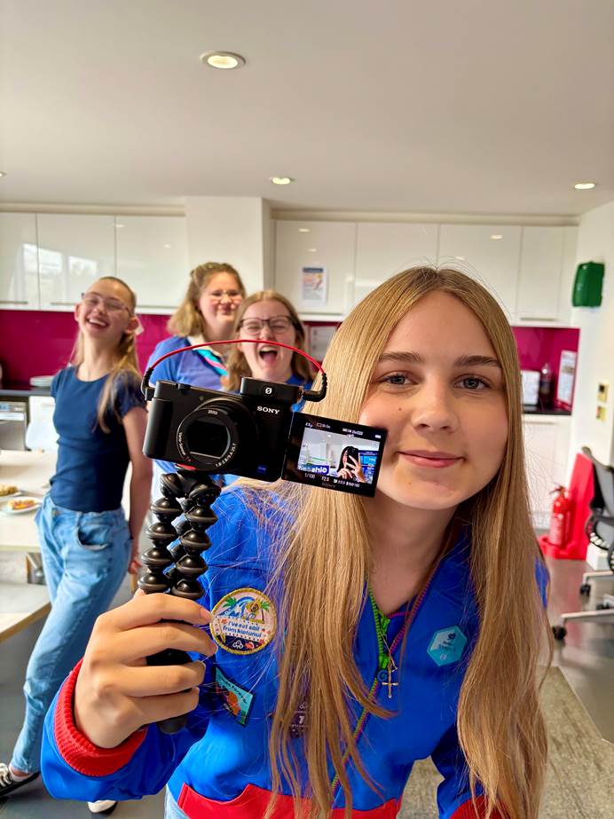 Girls from the creator collective creating content with a video camera