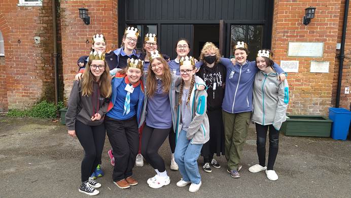Young leader working group wearing shiny gold crowns and smiling
