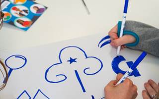 Girls drawing and colouring in trefoil
