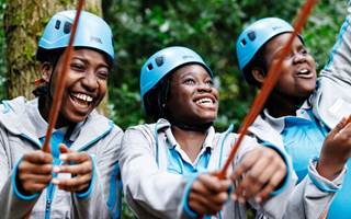 Girls wearing helmets and holding rope