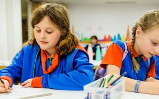 Two Guides doing crafts on a table