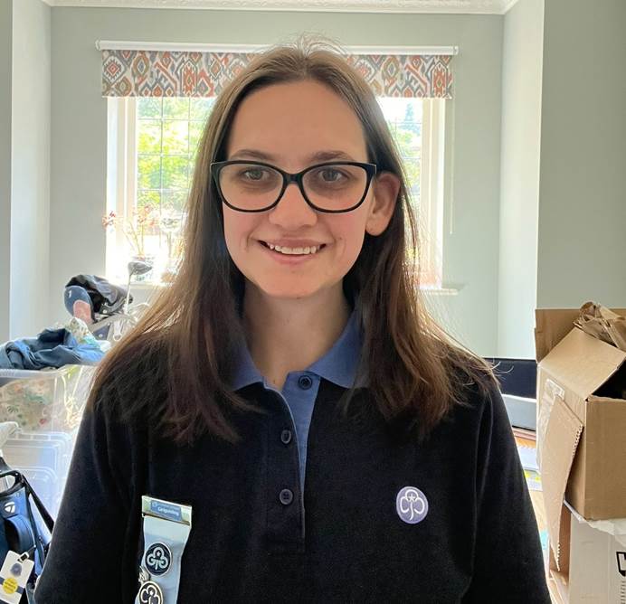 Volunteer Rachael, smiling at the camera and wearing her guiding volunteer uniform.
